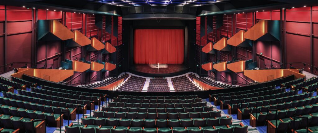 empty-theatre-auditorium-stage-with-a-red-curtain-